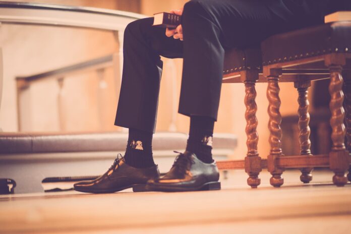 person sitting on a chair holding book