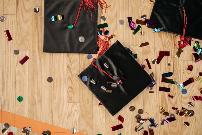 close up photo of academic cap on wooden flooring